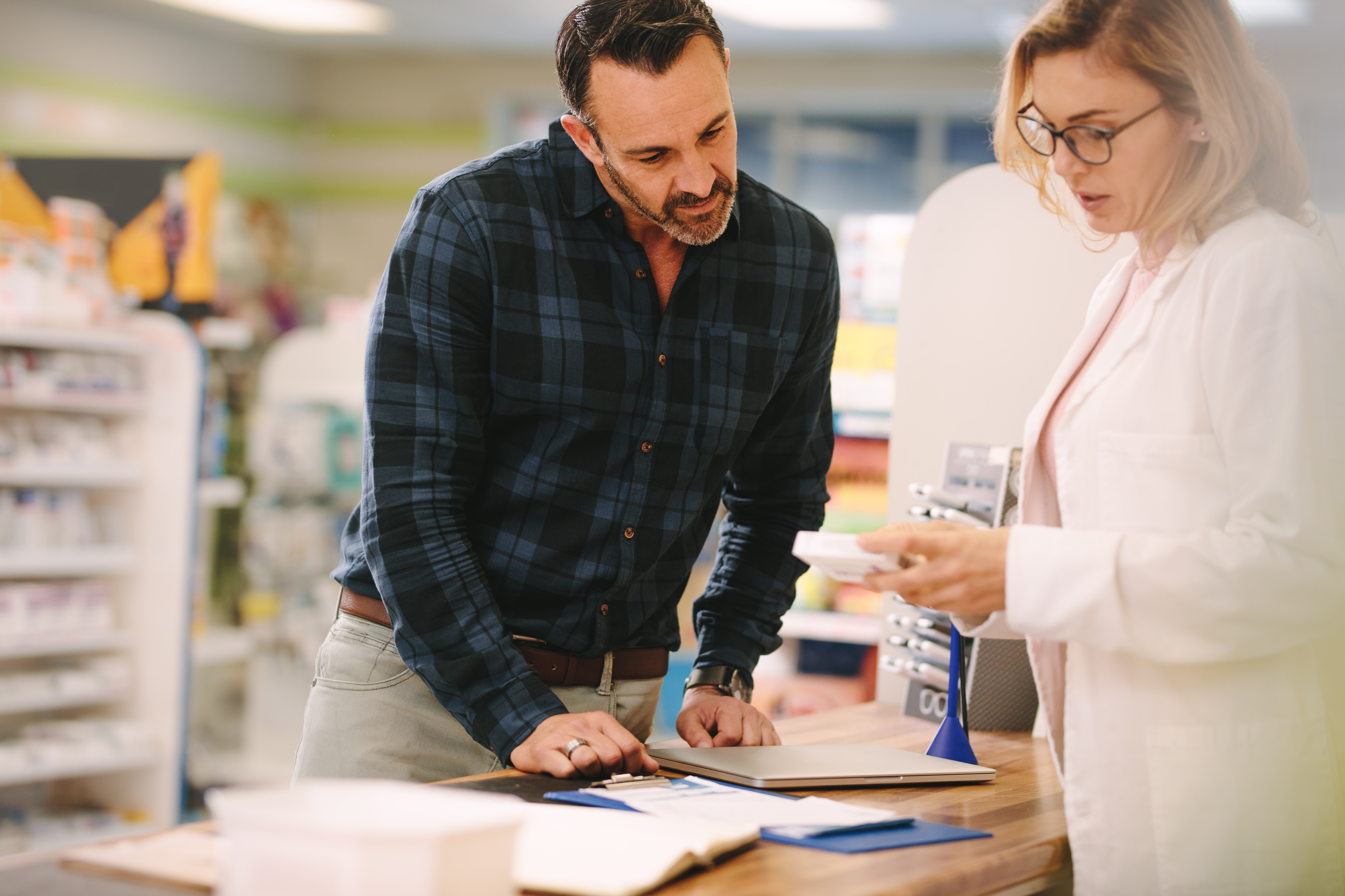 Patient speaking to pharmacist