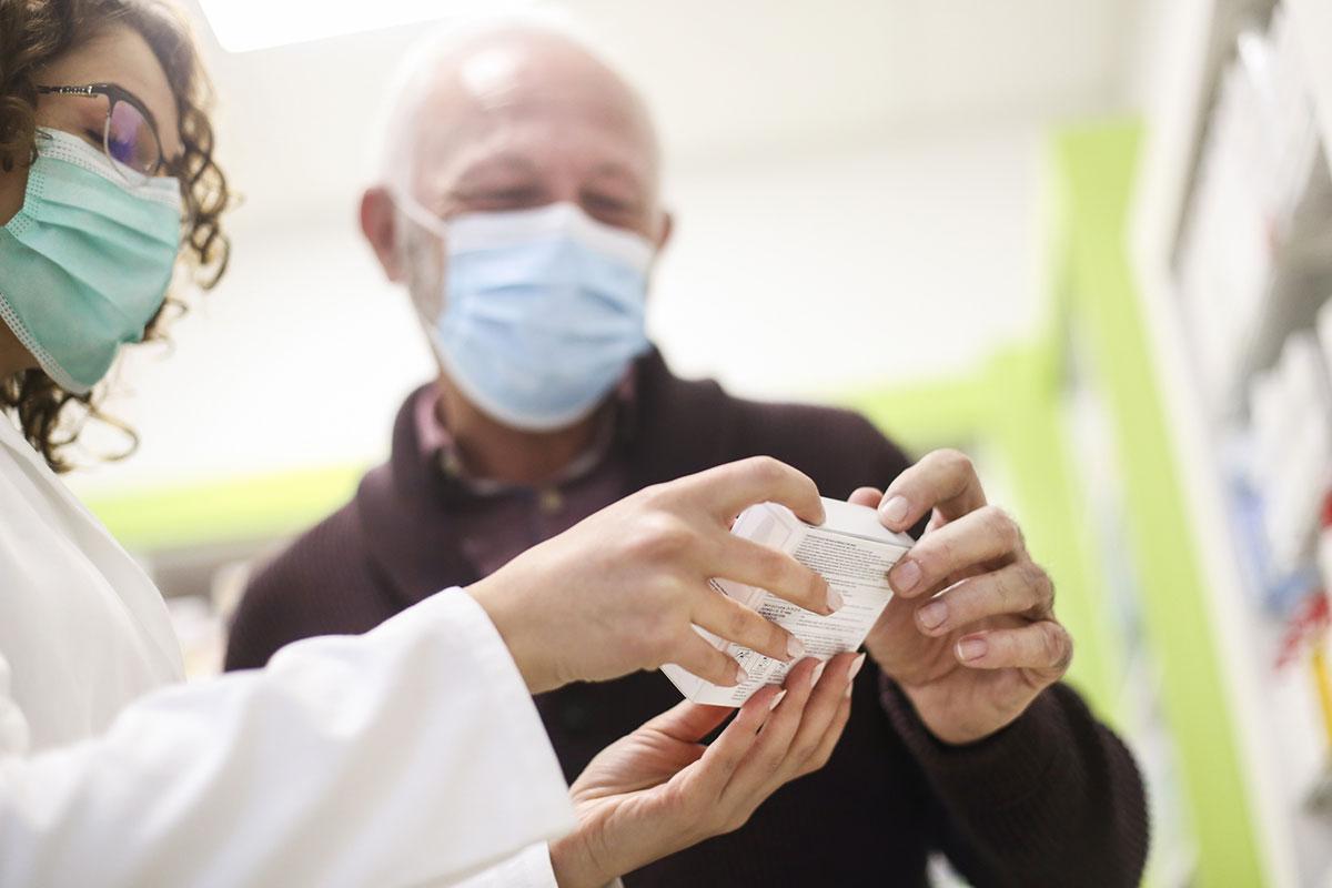 Man and pharmacist in a face mask