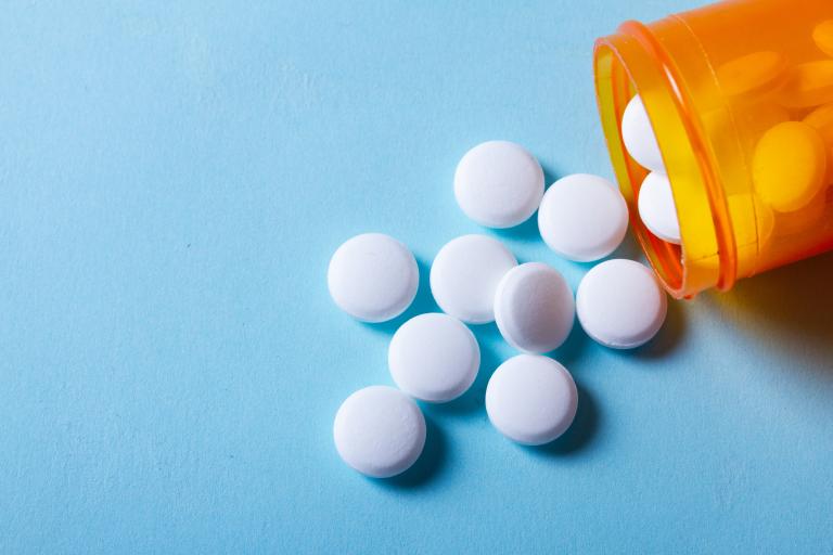 White pills on blue background