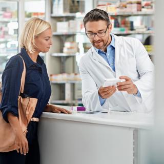 Man, pharmacist and help customer, prescription and explain instructions for medicine, vitamins and wellness.