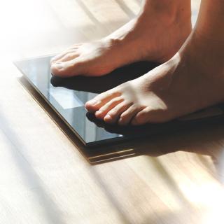 Feet on a scale for weight control after bathroom