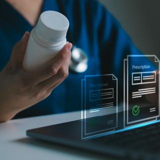 Doctor holding medicine bottle and using laptop with digital prescription icons, e-healthcare, e-prescription, digital healthcare, wellness, telemedicine and modern pharmacy solutions